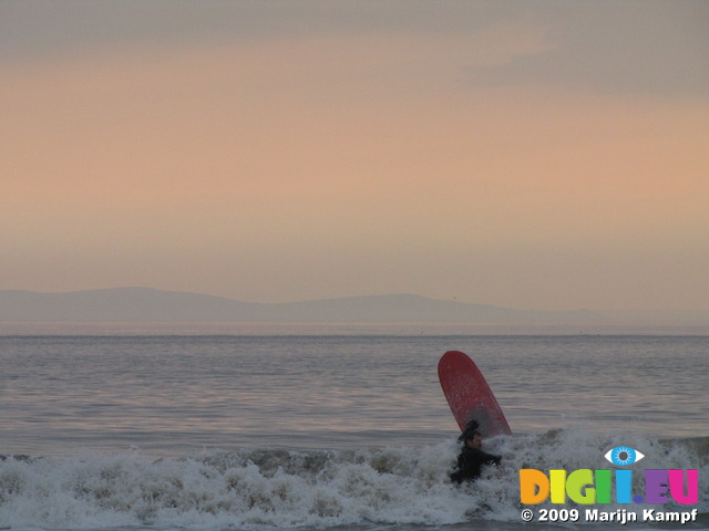 SX03511 Surfer in surf at Ogmore by Sea